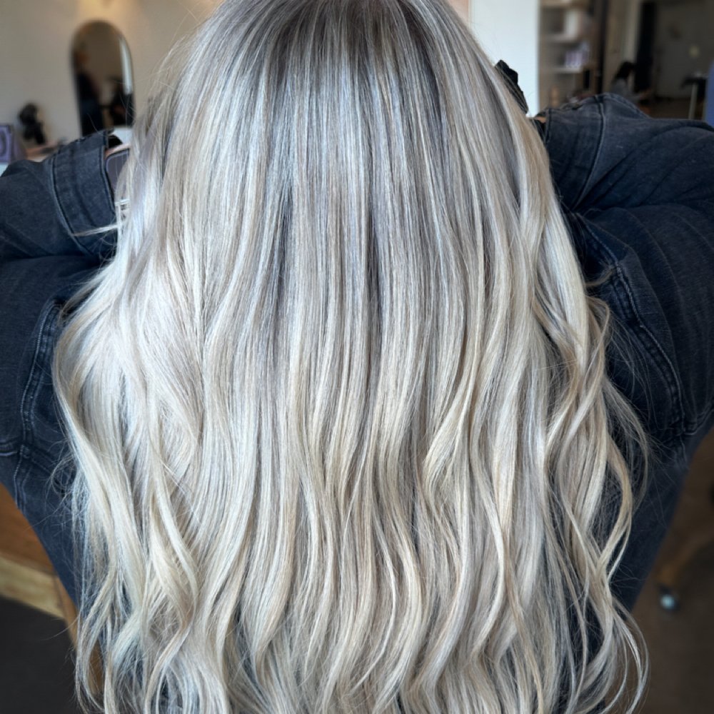 Bright blonde waves with a softly blended root